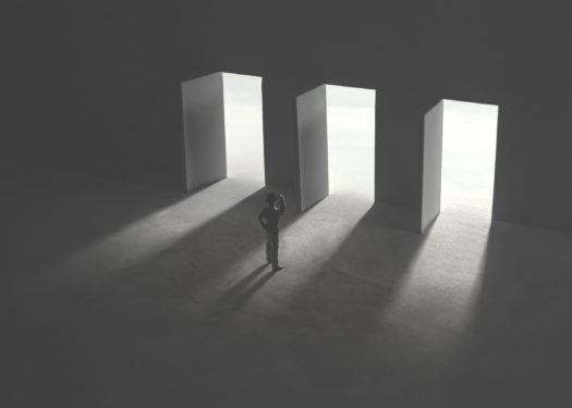 serie of images representing a business man in silhouette walking trough different shaped door in concrete wall